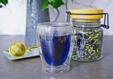 Hot  butterfly pea flower cup made from whole butterfly pea flowers in a tea baller